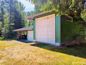 Middle garage can easily be converted into a DADU/MIL unit. Carports currently used for wood storage as seller heats the whole house with just the fireplaces!