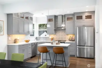 Sleek kitchen with breakfast island and stainless appliances.