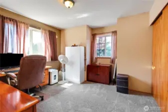 Bedroom with newer carpet facing the front and south side of the home.  Great natural light.