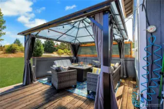 Back deck offers great relaxation with gazebo and privacy screen.  This area can be enjoyed anytime of the year.
