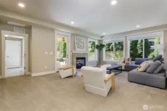Large family room at lower level with double side fireplace to covered patio
