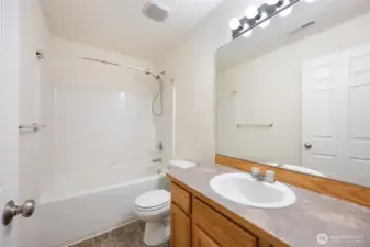 Primary bedroom full bath with storage & Bright lighting.