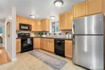 Open kitchen with granite title counters.