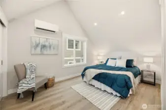 Primary bedroom also boasts vaulted ceilings along with its own mini split. LVP flooring throughout.