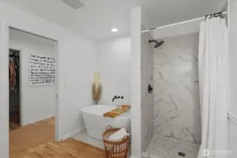 Newly updated primary bathroom with   freestanding soaking tub and walk-in shower.