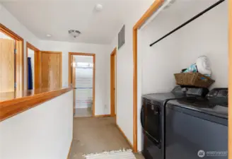 In the hall at the top of stairs, laundry area is conveniently located.