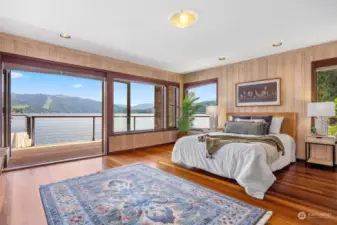 This spacious bedroom on the lake level that opens to the expansive wraparound purpleheart deck.