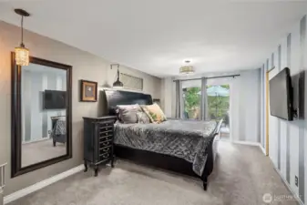 The primary bedroom is quite large and includes a sliding glass door to the beautiful and expansive trex deck.