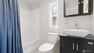 The full bath blends classic comfort with a touch of modern style, thanks to the eye-catching vessel sink.