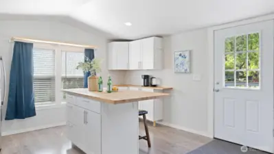 Warm butcher block counters and light-filled rooms give this home an inviting & welcoming feel from the moment you walk in.