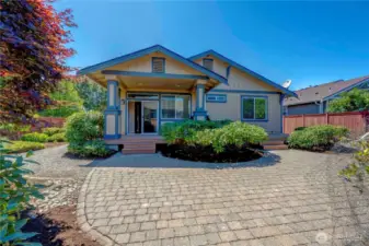 Professionally landscaped view of covered deck that stretches the entire width of the house.