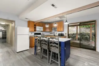 Great breakfast bar. This view looks down hall to lower level bedroom, bath, laundry space and garage entrance.