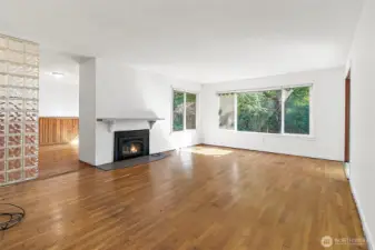 Large windows, door the outside on the left, electric fireplace may have option to convert back to wood