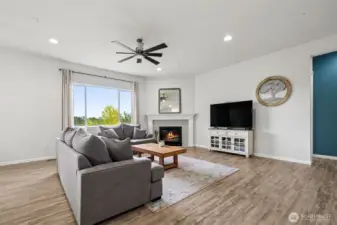 Great room with gas fireplace and luxury vinyl plank flooring.