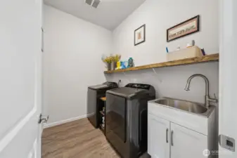 Laundry room with sink and shelving