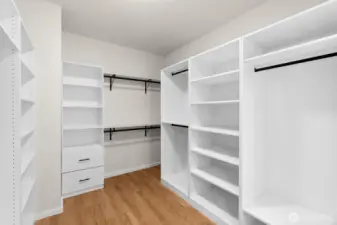 Light and bright custom walk-in closet off the primary bathroom.