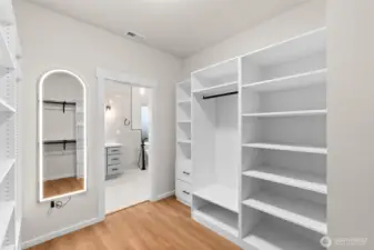 Walk-in primary closet featuring an LED-lighted mirror—both functional and thoughtfully designed.