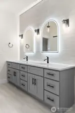 Modern bathrooms finished with sleek Kohler one-piece toilets and quiet Panasonic WhisperValue ventilation fans.