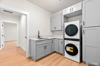 Outside the laundry room is the technology closet. The home is professionally wired Reolink 4-camera security system and a 28” metal media box provide peace of mind and future-ready connectivity.
