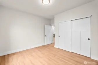 Another view of the second guest bedroom with ample closet space and large windows.