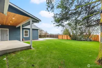 French doors connect the covered back porch to the kitchen and dining space for seamless indoor-outdoor living.