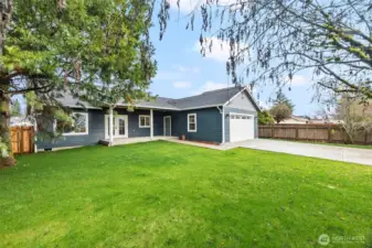 New fencing adds privacy to the backyard, with a partially fenced layout that allows for easy driveway enclosure.