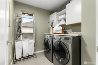 Dedicated laundry space with beautiful front loading washer and dryer.