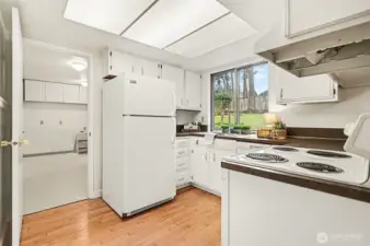 Laundry room plus 1/2 bath with a door to the yard.