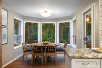 Spacious eat-in kitchen nook leads to upper outdoor deck.