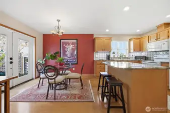 Looking at the spacious kitchen and dining areas that open to the amazing back patio and gardens.