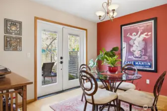 The dining area is light and bright with the French doors that open to the fully enclosed, private back patio.