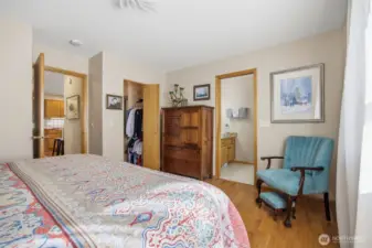 Looking across the primary bedroom toward the spacious walk-in closet with the hallway to the kitchen on the left.