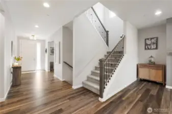 Check out the gleaming floors - beautiful and durable for both the 2-legged and 4-legged members of your crew! Gorgeous wrought-iron railings, too! This is the main-floor entry (with the great room mostly to your back).
