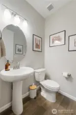 Feng shui-friendly 1/2 bath on the main floor does NOT open to the kitchen or dining. It's tucked away privately, just like it should be.