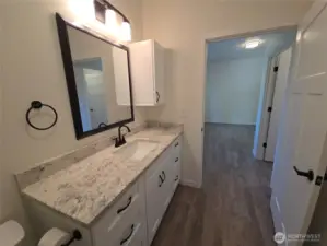 primary vanity with upper cabinet for handy items