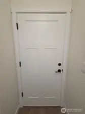 White painted 3 panel doors and black hardware throughout