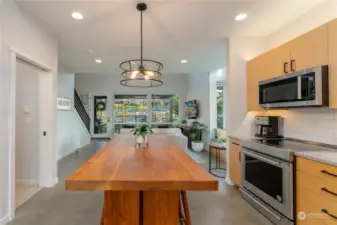 View of kitchen area w/ custom dining room table.