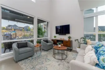 View 2 of the Great Room/Living Room w/ vaulted ceilings, oversized windows and doors leading to the outdoor living area.