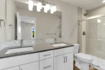 Primary bath for homesite 2. Beautiful backsplash and tiled shower.
