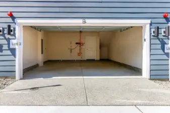 Side x Side 2 car garages with nook for storage. Garages include sheetrock, painged, and EV outlet.