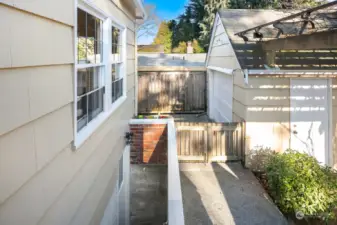 Back gate leading to driveway & stairs to basement