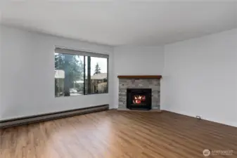 Beautiful wood fireplace with updated surround and mantle.