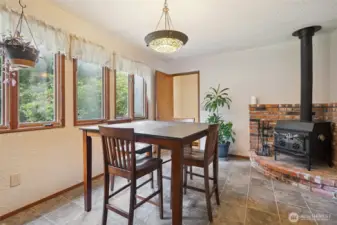 Dining area off kitchen, wood stove in the corner