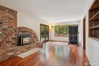 Family room just off entry with kitchen on the left and door to the backyard on the right. Unique brick fireplace design and Brazilian Cherry hardwood floors here too