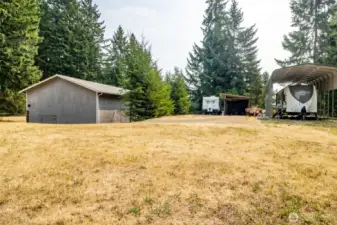 Covered RV parking and large yard area