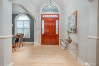 Elegant entry welcomes you with soaring ceilings, arched transom window, expansive custom trim.