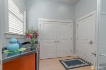 Another view of the butler’s pantry, showcasing an expansive storage closet and convenient access to the fully finished 3-car garage—combining style with function.