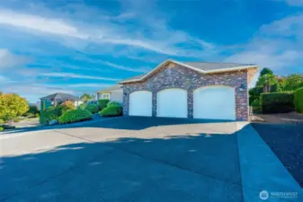 Impressive curb appeal with exposed aggregate concrete driveway, classic brick accents, and a fully finished 3-car garage offering ample parking and storage.