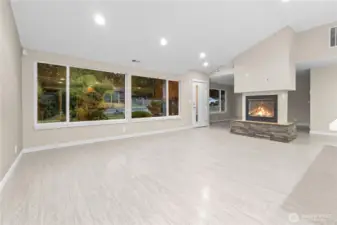 Great room with gas fireplace and luxury Vinyl  Plank flooring. Large windows for great natural lighting.