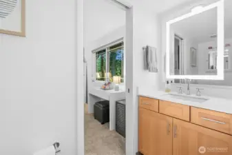 Updated bathroom sinks, countertops, fixtures, lighted mirrors, bathtub and shower tile, and sleek tile flooring